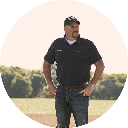 Kris Reynolds Illinois Farmer who grows soybeans standing with his arms on his hips looking to his left